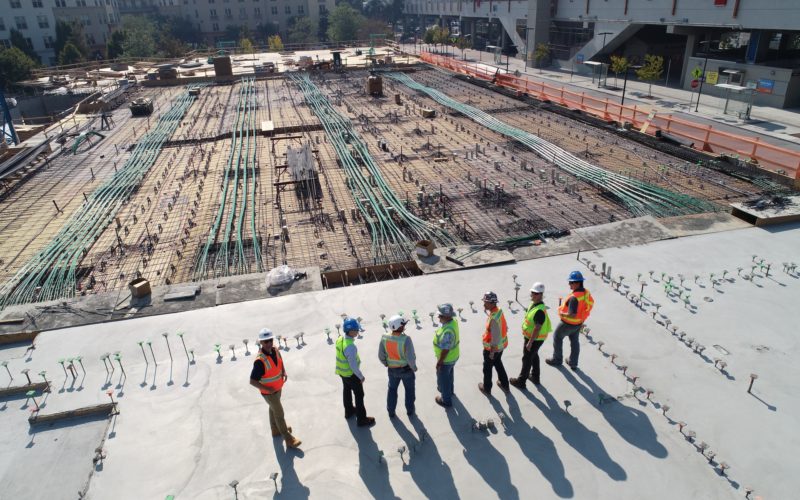 Men in PPE looking at the construction site