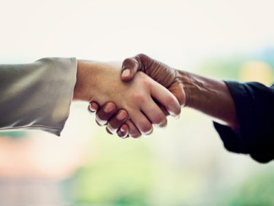 Cropped shot of unrecognizable businesswomen shaking hands in the office