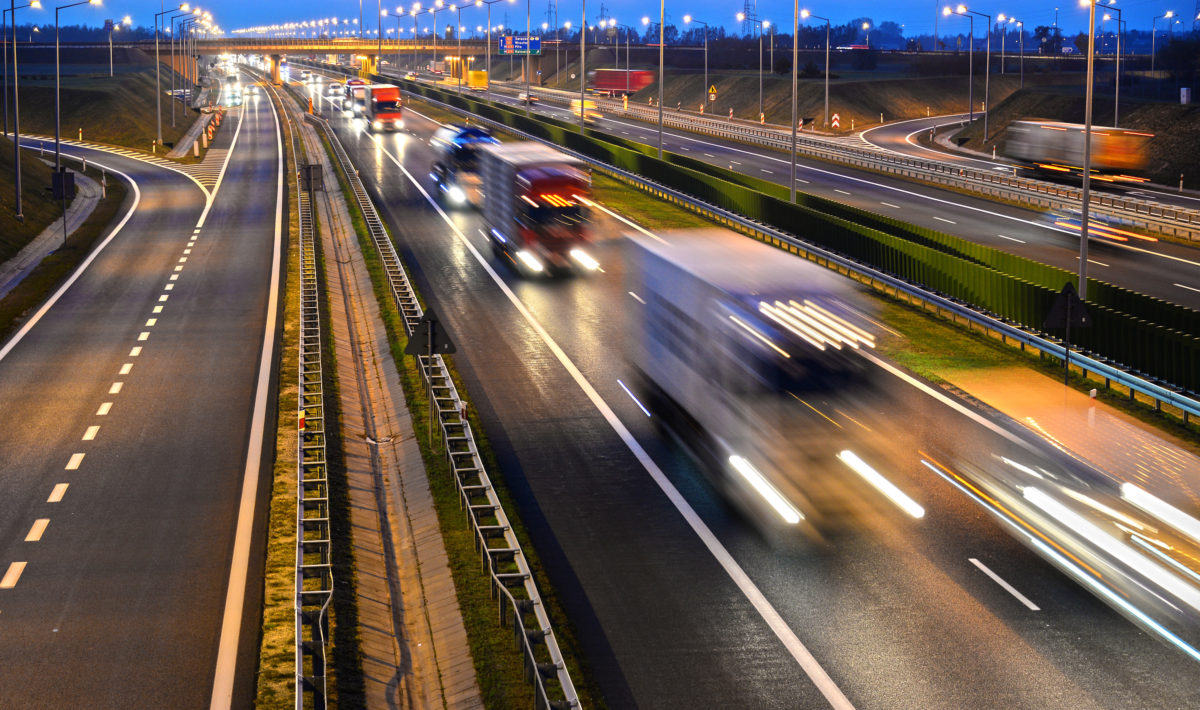 view of moving cars on a motorway at dawn