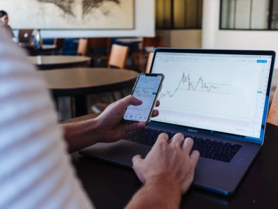 A person viewing the same graph on a mobile and laptop screen