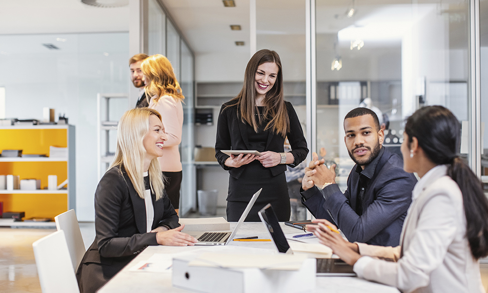 A group of coworkers meeting to discuss trending topics