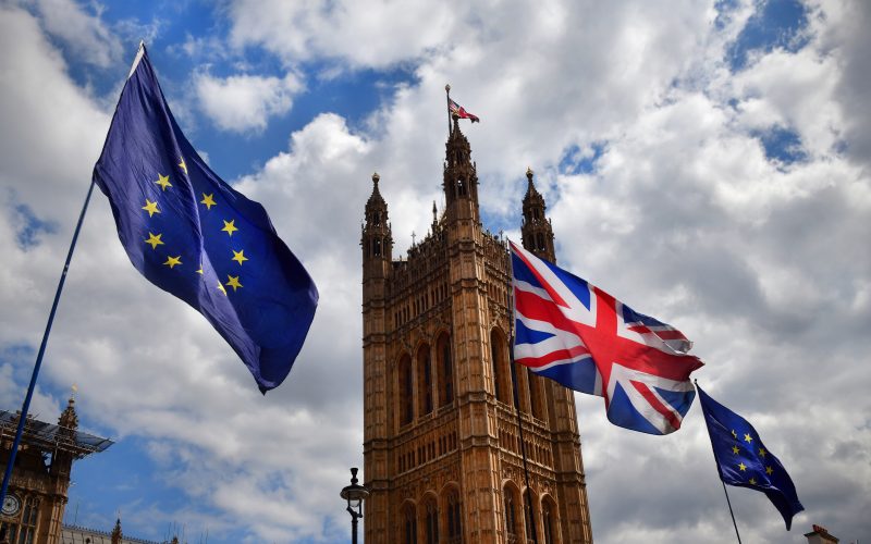 The European Union and UK flags flying outside tje House of Parliament in London as part of a Brexit protest