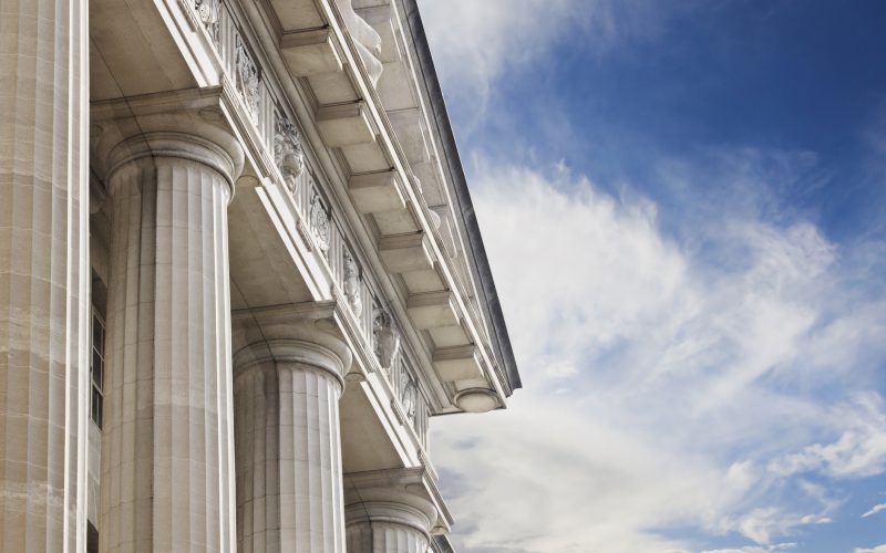 A close up look at a courthouse or government building on a blue skies background