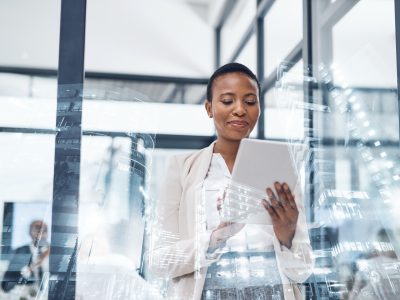 Multiple exposure shot of a mature businesswoman using a digital tablet in a boardroom superimposed on a cityscape