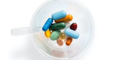 pharmaceutical meds in a clear container from above, symbolizing pharma transparency
