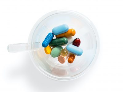pharmaceutical meds in a clear container from above, symbolizing pharma transparency