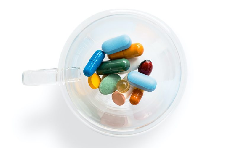 pharmaceutical meds in a clear container from above, symbolizing pharma transparency