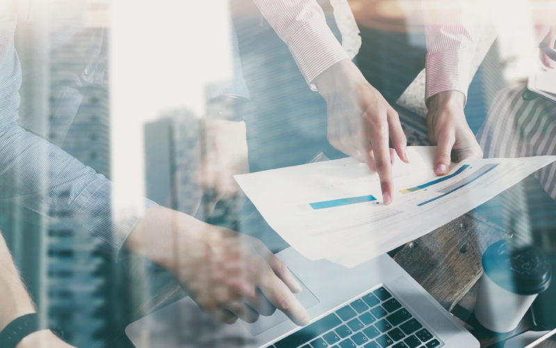 Business people brainstorming concept.Skyscraper building on the blurred background.